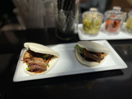 Roasted Duck Buns: Steamed Chinese bao buns, roasted duck, cucumber, pickled carrots & daikon, cilantro, hoisin sauce