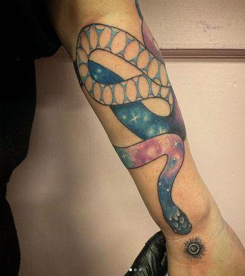 Cosmic snake on left forearm