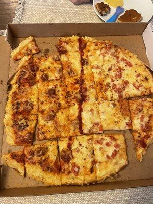 This is by far the dumbest way I have ever seen a pizza cut. left an entire row with pieces that were two different toppings.