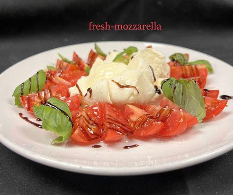 Mozzarella Caprese made with homemade mozzarella, balsamic glaze and fresh basil