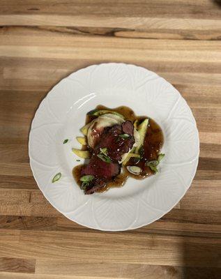 Steak with mashed potatoes, zucchini and squash topped with a Demi glaze