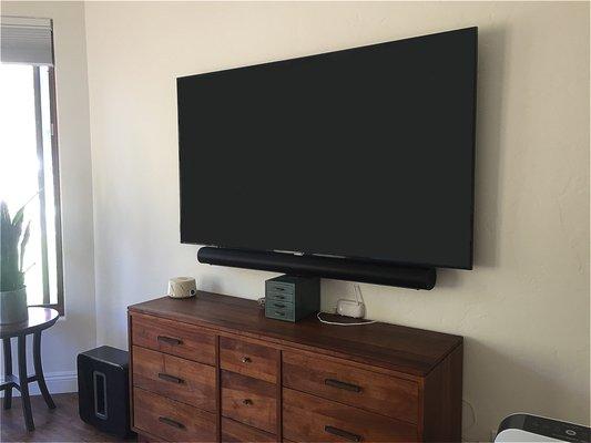 TV and sound bar wall mounting. No wires visible. Meticulous and neat looking.