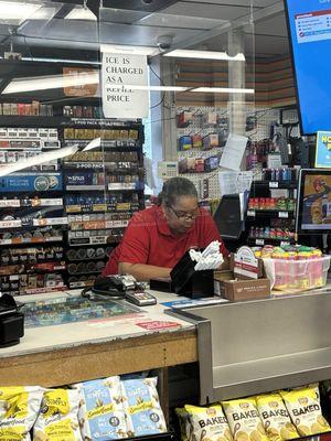 Attendant too absorbed in phone to pay attention to customers.