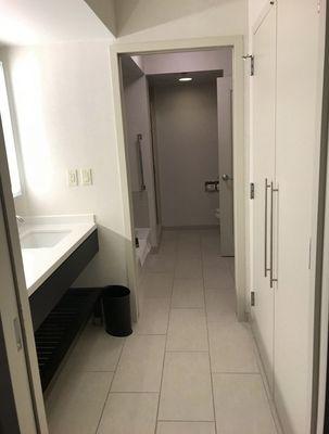 The bathroom situation with three separate doors for sink, tub, and toilet