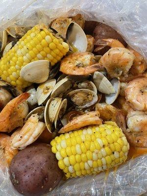 Shrimp(minus head), white clams, potatoes and corn in garlic butter.