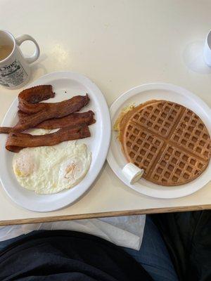 Waffle, eggs over easy and crisp bacon