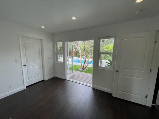 A view out of our brand new room and door to walk-in closet to the backyard thanks to Value Up Renovation and Construction.