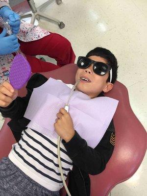 This cool guy is getting his pearly whites checked up on.