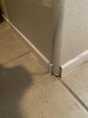 Broken baseboard and obviously not clean tile