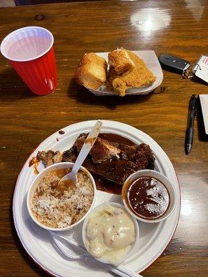 Rib & chicken combo Rib Dinner with red beans and rice with mashed potatoes.