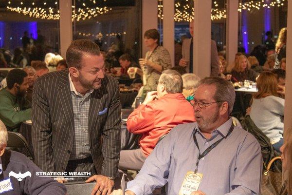 Dustin enjoying a fun conversation with an attendee at a recent financial planning Wine and Wisdom event