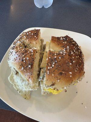 Sausage, egg, cheese, cream cheese on an everything bagel