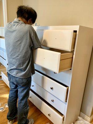 Installing the silver knobs to my new dressers