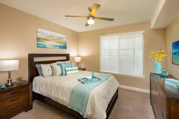 Bedroom with lighted ceiling fan at Southern Ave Villas