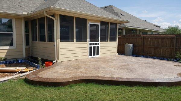 Comcrete patio extension with stamp and stain and patio enclosure