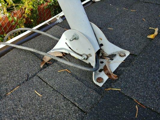 No self sealing membrane where satellite dish anchors penetrate roof. Potential roof leak