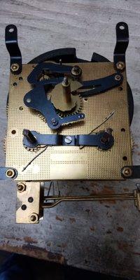 Front of small mechanical clock.