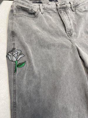 covered a hole with embroidering a gray rose the customer requested