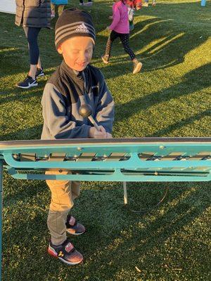 My son playing the giant xylophone