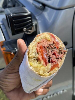 The Devour Heartburn Wrap. that consists of pastrami, beef hotdog peppers, coleslaw, and stewed onions. A delightful cacophony of flavors.