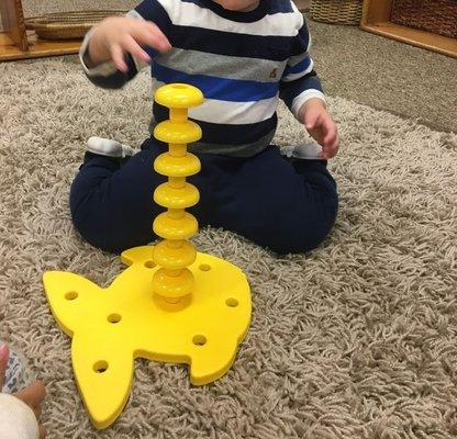 15 month old stacking (I assume they were supposed to go in each hole, but I'm impressed)