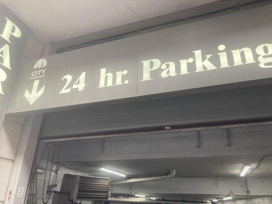 Prominent, glowing "24 hr. Parking" signage