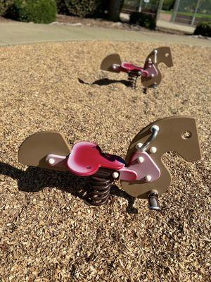 Rocking horses on small playground your find when you cross the bridge & walk the bike trail!