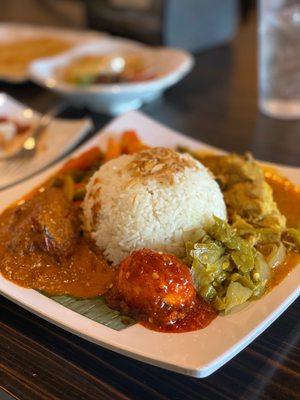 #21 Nasi Padang $11.99. Curry veg, beef rendang, coconut chicken, chili egg, green chilies. Pretty good dish, spicy and very filling.