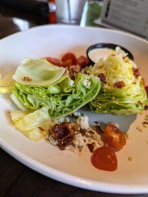 Iceberg Wedge salad, side size. $6. Iceberg lettuce, blue cheese crumbles, tomatoes & chopped bacon with dressing of your choice.