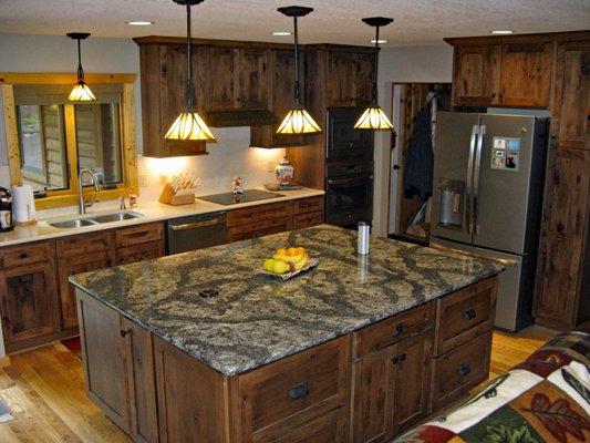 A kitchen island with a granite top and plenty of storage creates a focal point for entertaining.