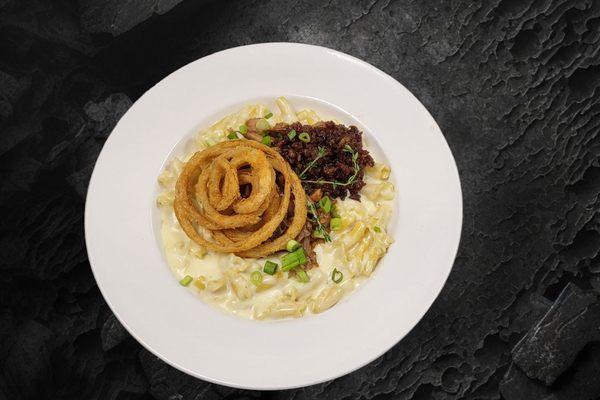 Chef's Mac Special Maple whiskey infused, white cheddar mac n cheese, BBQ pulled pork, bacon jam and onion rings