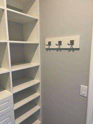 Bedroom closets were customized with drawers, hanging spaces, shoe shelves and pull out hamper drawer.  A peg board for coats, purses etc