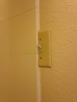 Light switch attached to the shower.