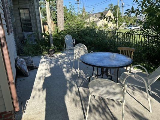 Patio could use some pruning trimming and more outside furniture.