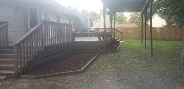 Cleaning out and adding mulch to flower bed.