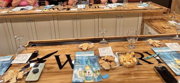 Wine tasting section with complimentary cheese and crackers.