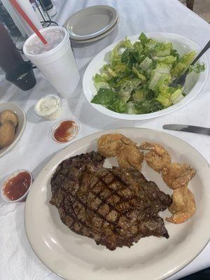 Steak and side of fried shrimp with a Caesar salad!