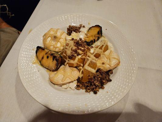 Peach cobbler with vanilla cookies over pecan crumb with caramel drizzle