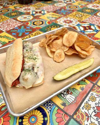 House-made Meatball Sub with Fresh Made Chips. Featuring Polk's Folly Farm's Red Chile Pork!