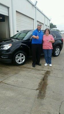 My mom with her awesome sales rep and new car!