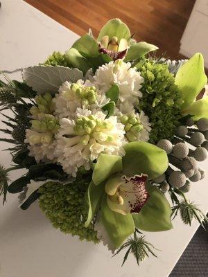 Glacier bouquet created by Rouvalis Flowers (Silver brunia, thistle, dusty miller, cymbidium blossoms and peach hyacinth)