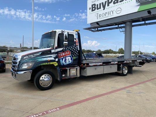 Our truck is standing near our customer in dallas, wheel lift tow truck/flatbed tow truck available.