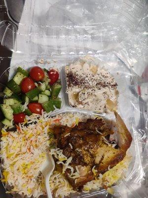 Chicken, hummus, rice & cucumber tomato salad.   Food flavorful.  Pic missing a piece of chicken