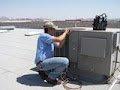 Technician repairing a Commercial Air Conditioner.