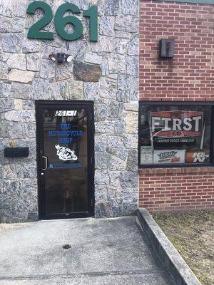 The motorcycle shop front door facing Skidmore's Road