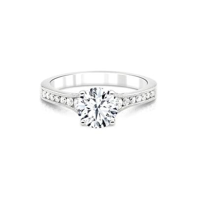 Round brilliant diamond engagement ring with tapered channel sides and milgrain edge.