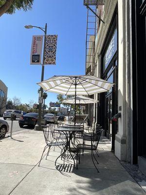 Some outdoor seating on the sidewalk