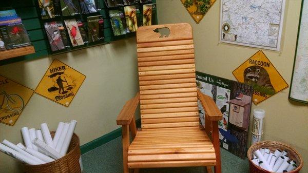 This chair is located in the reading room which is stocked with books, signs and posters.