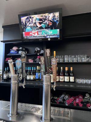 One side of the bar tap and a football game.