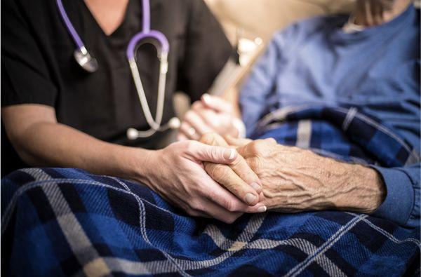 Holding senior's hand through their last stage of life. Hospice provides patients empowerment and dignity